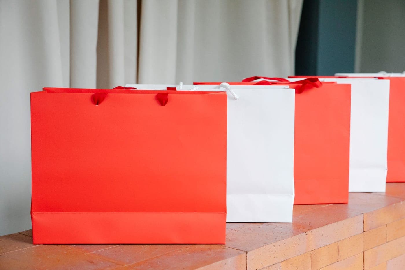 A gift shop counter with a paper bag and wrapped parcel