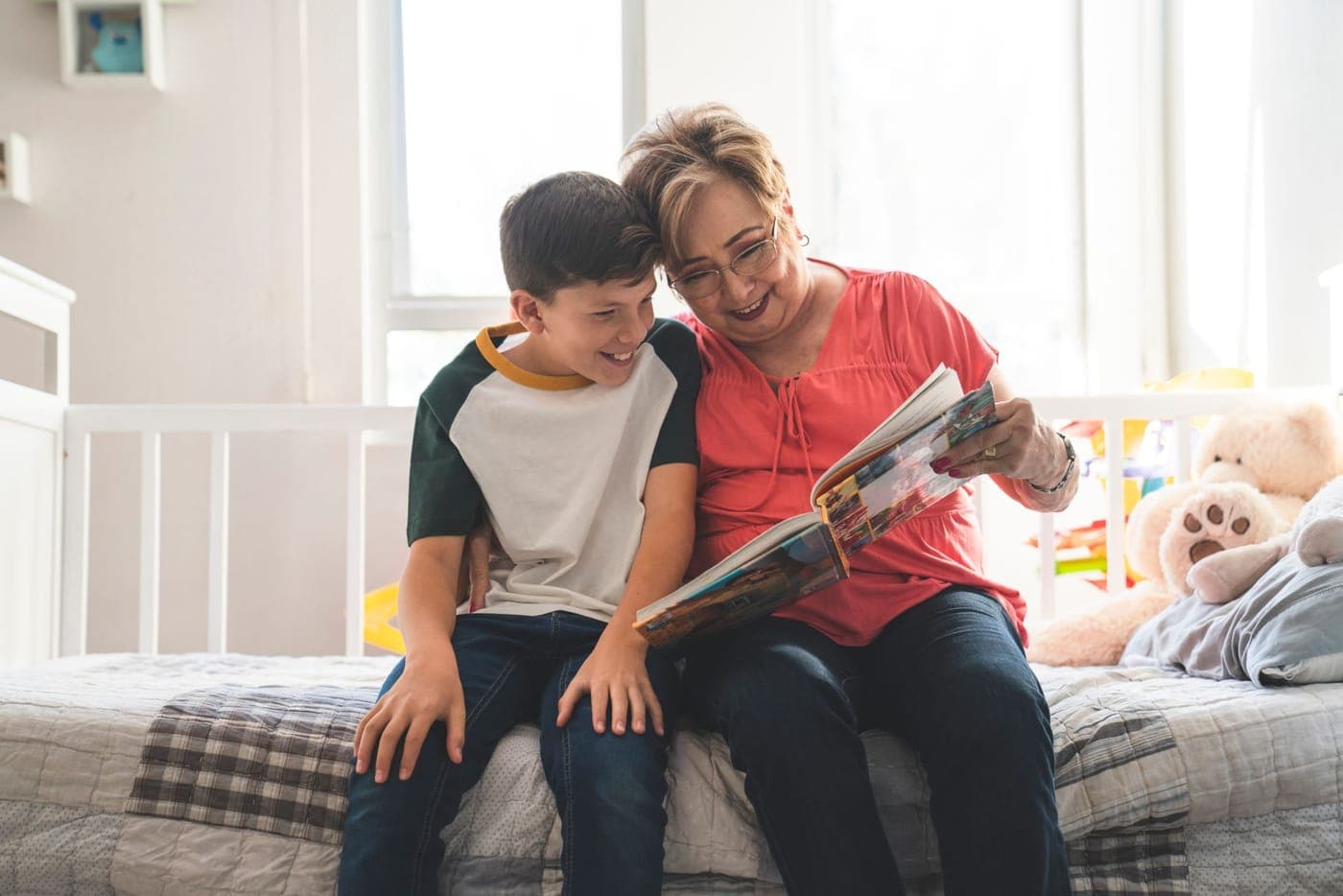 A grandparent and grandchild reading a book together