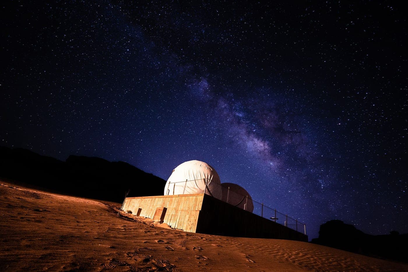 A star field over a dark horizon