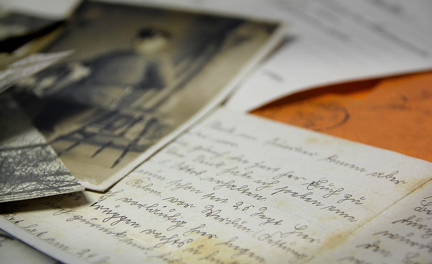 Old letters and a magnifying lens on a desk