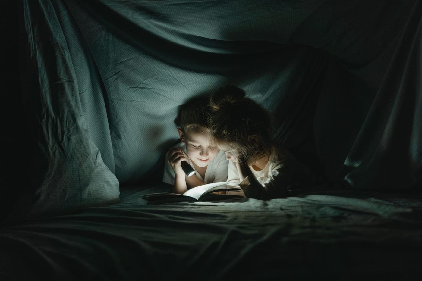 A book and blanket in a comfortable reading corner