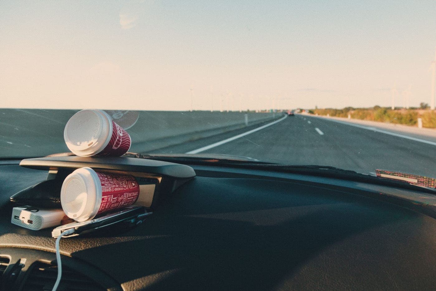 An open highway seen from a car dashboard