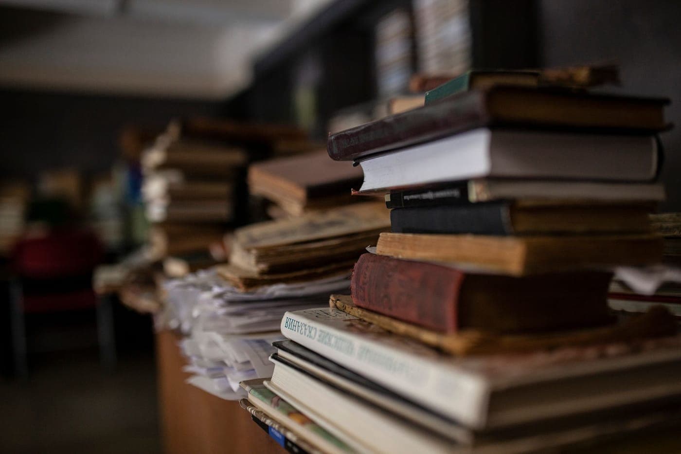 A stack of hardback books on a table