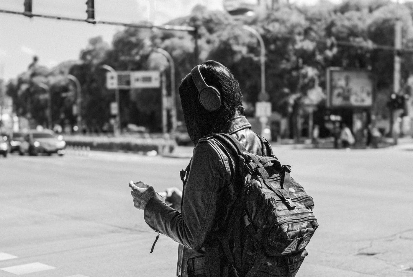 Someone walking outdoors wearing headphones