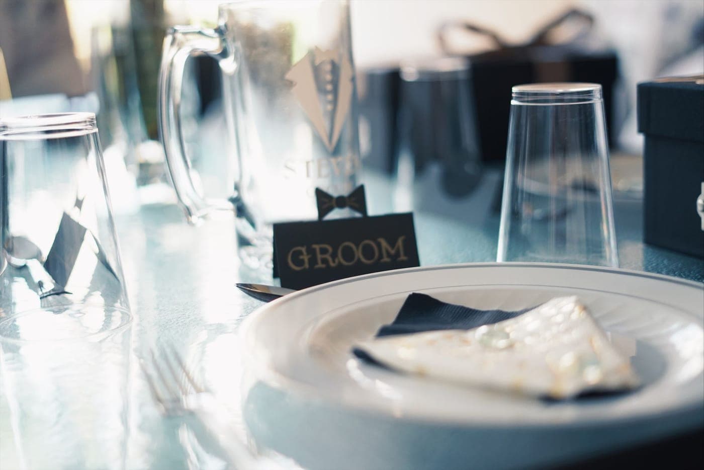 A wedding reception table set with flowers and place cards